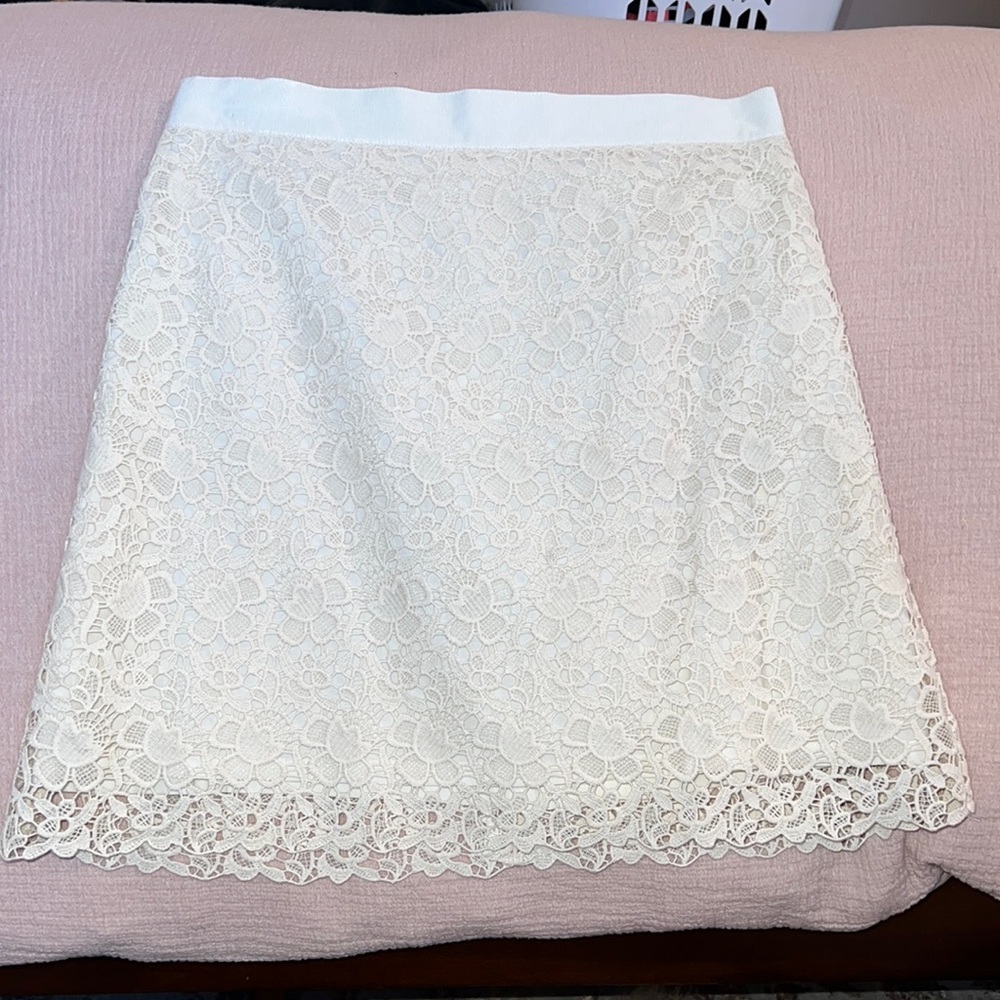 textured skirt in ivory with liken like lining.  Hits just at/above knee.